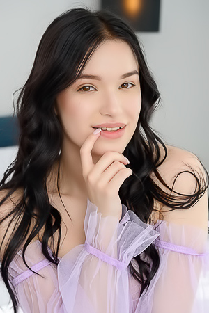 Wikki K Entices As She Spreads Her Long Legs Invitingly On The Bed