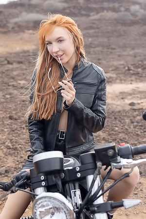Lilly Mays Rides A Motorcycle In The Desert Wearing A Leather Jacket And Miniskirt