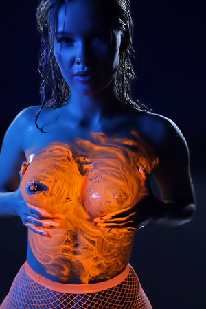 Ira Veter Kneels Nude In Neon Lingerie And Fishnets Smearing Glowing Paint On Her Wet Body