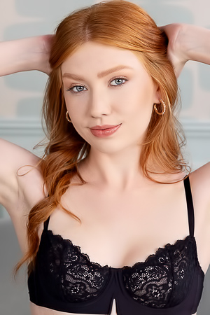Sophia Mae Spreads Legs In Sheer Lingerie On Plush Couch Playfully