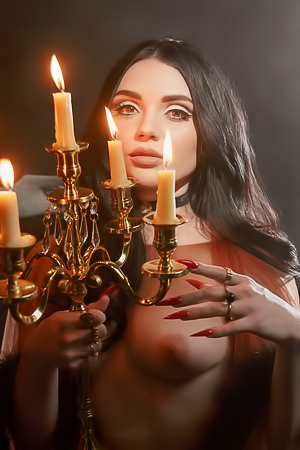 Catjiras fingers tremble near the flickering candles heat, smoke curling around her nude form
